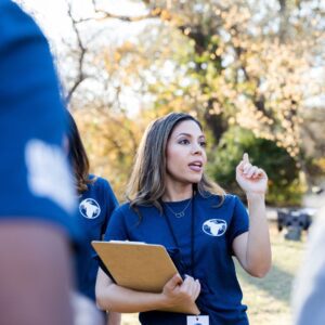 A person talking to a group of people, duties of a marketing coordinator